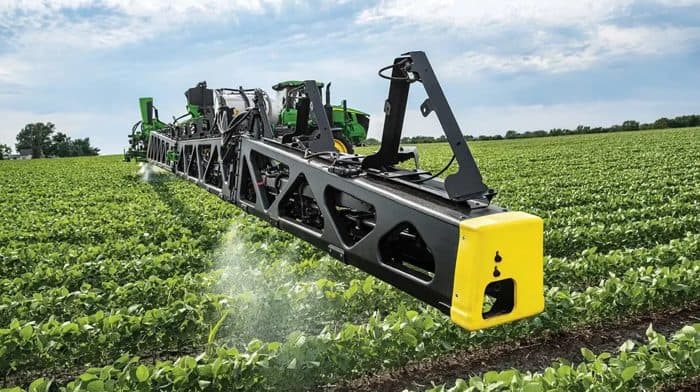 John Deere See and Spray sprayer boom in a soybean field